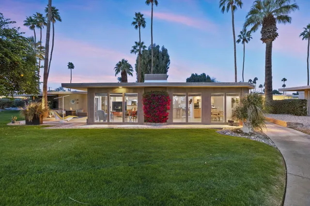 a front view of a house with swimming pool having outdoor seating
