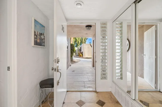 a view of a hallway with wooden floor and windows