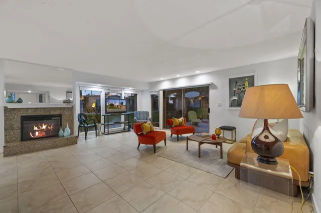 a living room with furniture a lamp and a fireplace