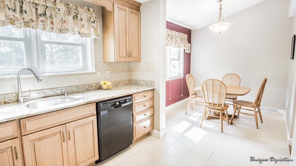 10 Evergreen Way, Unit 10 Peabody, MA 01960 - Photo 6 of 24 a kitchen with a sink stove and chairs