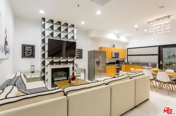 a kitchen with stainless steel appliances a refrigerator and a stove top oven