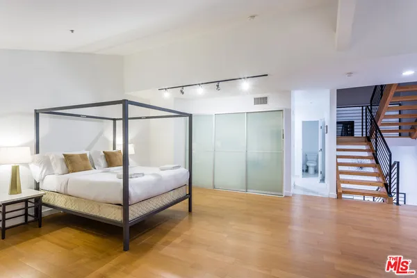 a bedroom with a bed and a walk in closet