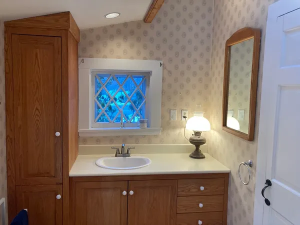 a bathroom with a sink and a mirror