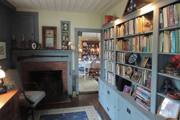 a living room with lots of books and a book shelf