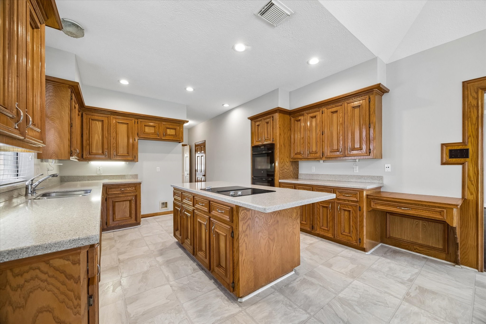 1707 Rambling Stone Drive Richmond, TX 77406 - Photo 12 of 42 a kitchen with stainless steel appliances granite countertop wooden cabinets a sink dishwasher and a stove
