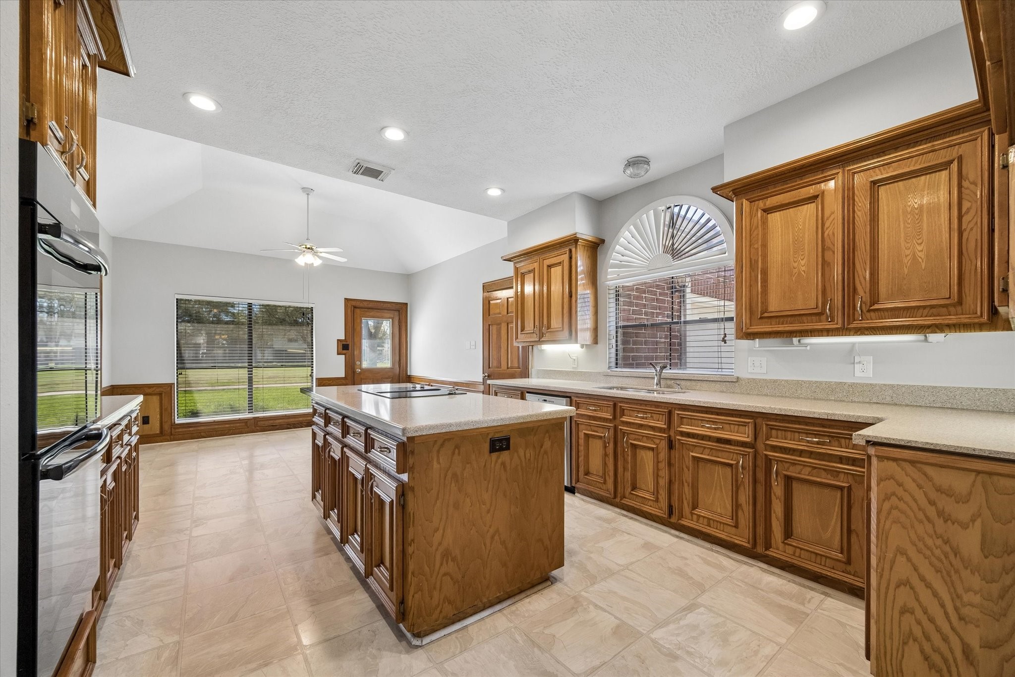 1707 Rambling Stone Drive Richmond, TX 77406 - Photo 14 of 42 a kitchen with a stove top oven sink and cabinets