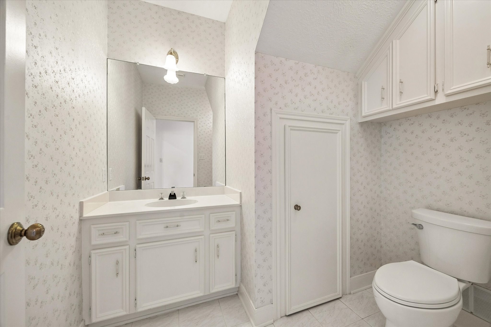 1707 Rambling Stone Drive Richmond, TX 77406 - Photo 17 of 42 CONVENIENT FIRST-FLOOR HALF BATH WITH VANITY STORAGE AND CLASSIC FINISHES FOR GUEST USE.