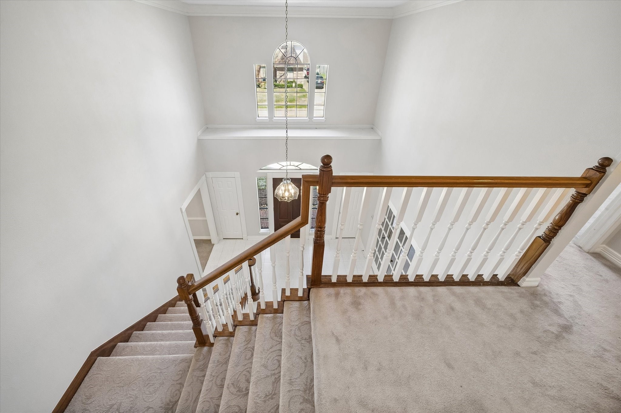 1707 Rambling Stone Drive Richmond, TX 77406 - Photo 21 of 42 OPEN UPSTAIRS LANDING OVERLOOKING THE FOYER WITH HIGH CEILINGS, WOOD RAILINGS, AND ABUNDANT NATURAL LIGHT.