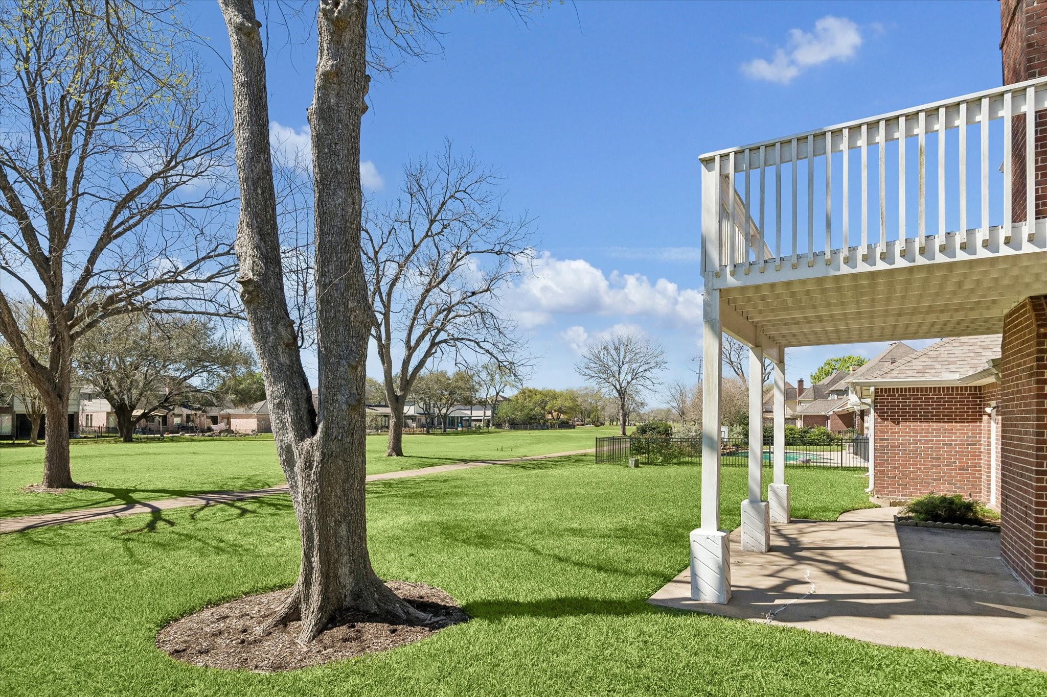1707 Rambling Stone Drive Richmond, TX 77406 - Photo 31 of 42 EXPANSIVE BACKYARD WITH MATURE TREES AND A COVERED PATIO, PLUS AN UPPER-LEVEL BALCONY OVERLOOKING THE GOLF COURSE.