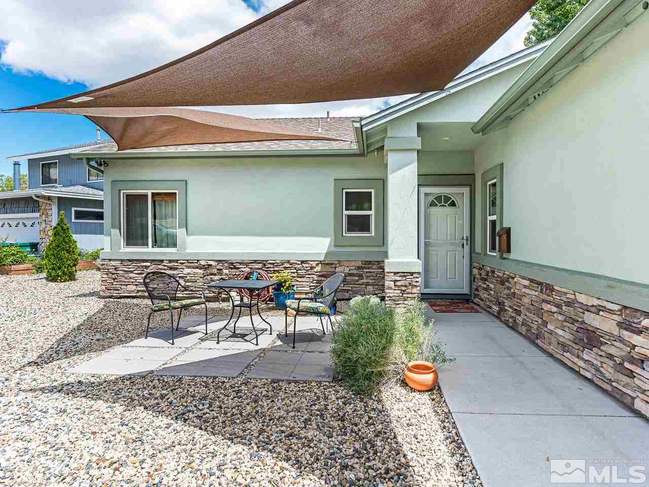 760 Barry M Circle Reno, NV 89503 - Photo 3 of 24 a backyard of a house with yard and outdoor seating