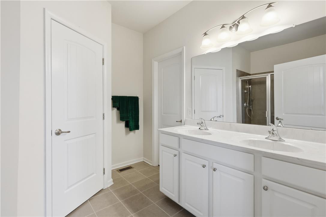 4120 Eveningstar Road Emmaus, PA 18049 - Photo 40 of 62 Dual vanity sinks and a spacious shower elevate daily routines in this well-appointed bathroom.