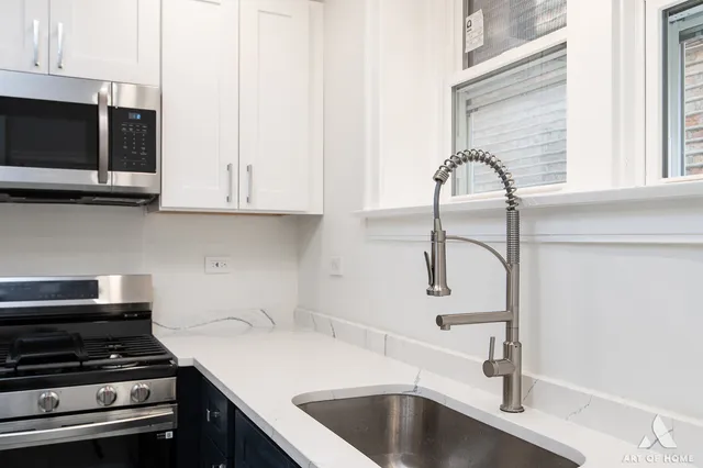 a kitchen with a sink and cabinets