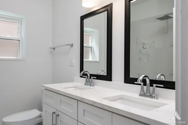 a bathroom with a toilet sink and mirror