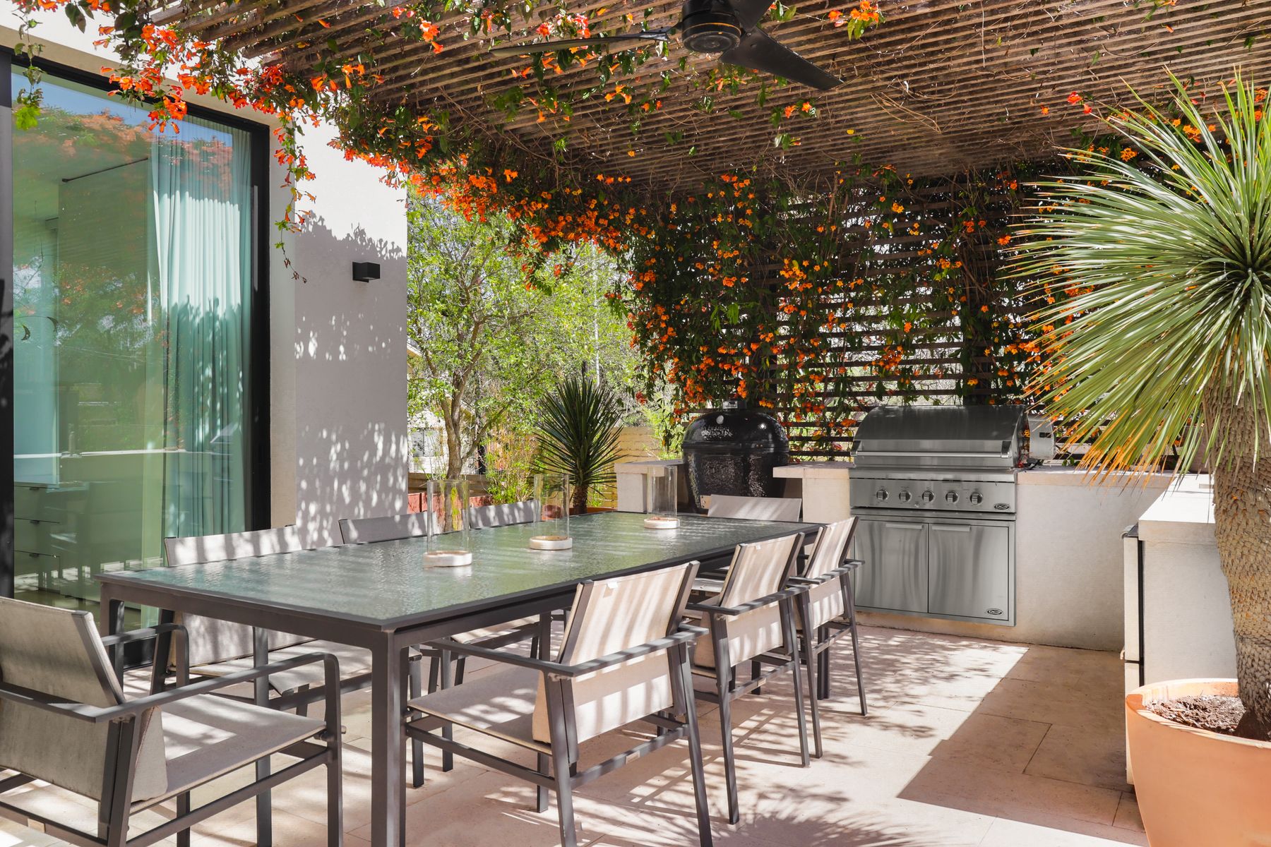 303 Farley Trail Austin, TX 78746 - Photo 13 of 18 a view of an outside dining space with a table and chairs