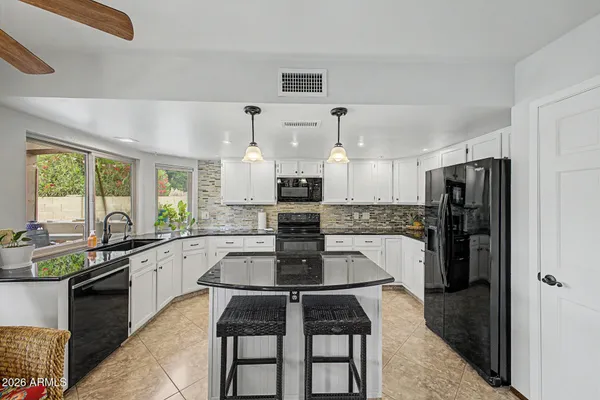 a kitchen with stainless steel appliances a stove refrigerator sink and cabinets