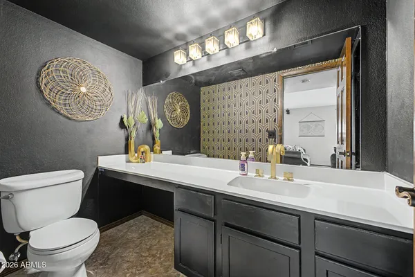 a bathroom with a toilet a sink and a mirror