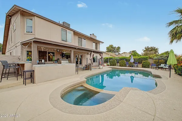 a view of a swimming pool with outdoor seating