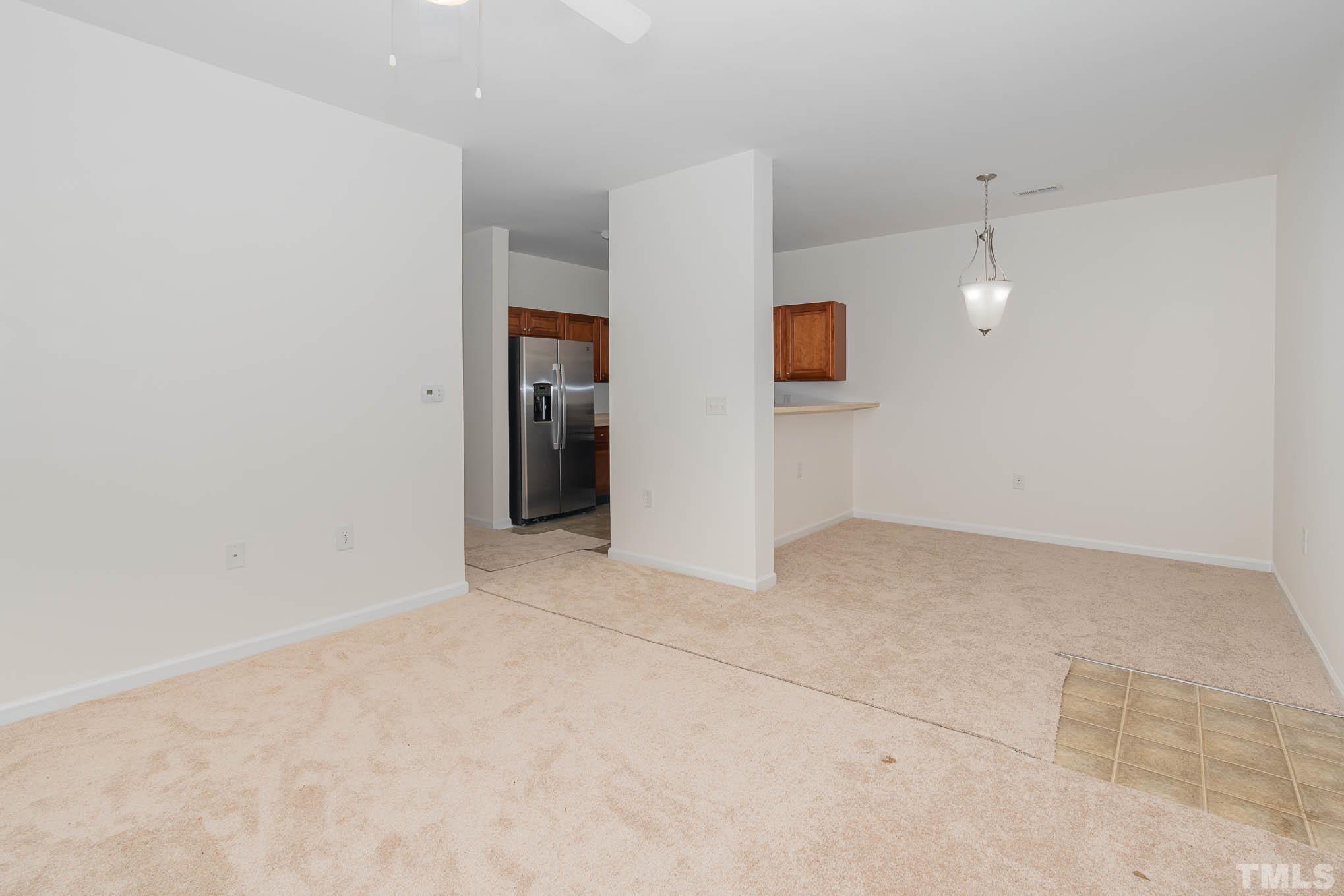 2631 Oldgate Drive, Unit 103 Raleigh, NC 27604 - Photo 4 of 15 an empty room with projector and white walls