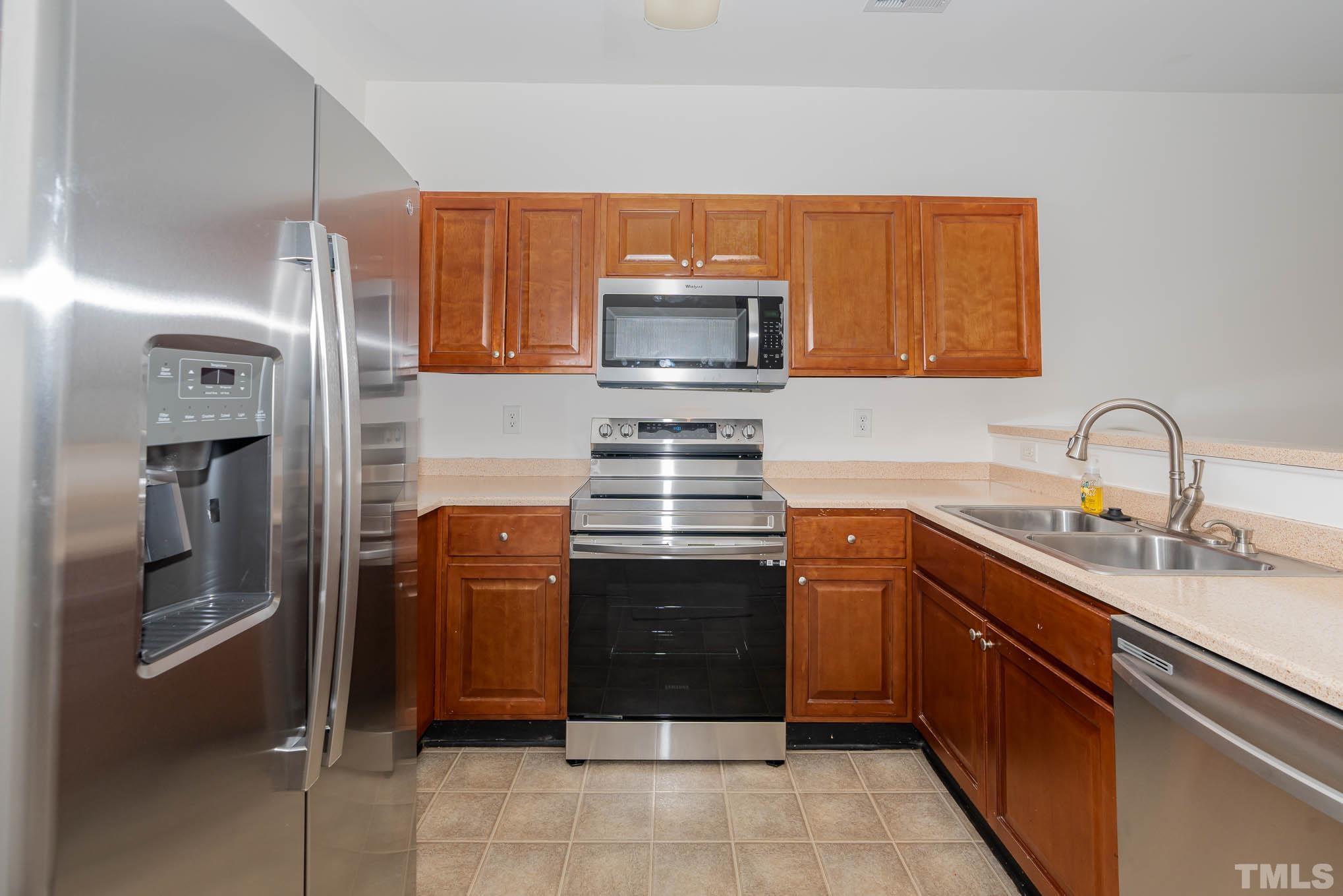 2631 Oldgate Drive, Unit 103 Raleigh, NC 27604 - Photo 6 of 15 a kitchen with stainless steel appliances granite countertop a stove and a sink