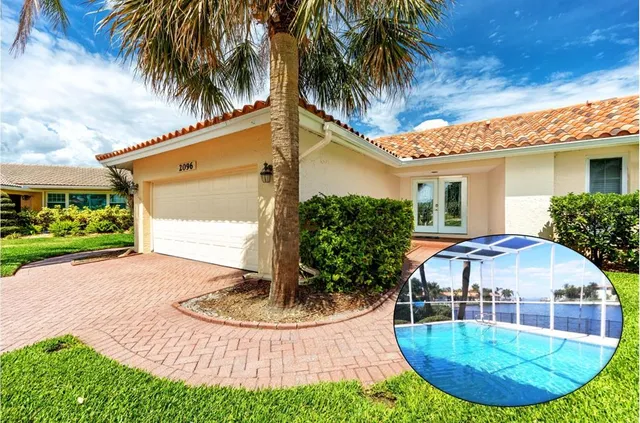 a view of a house with a swimming pool and sitting area