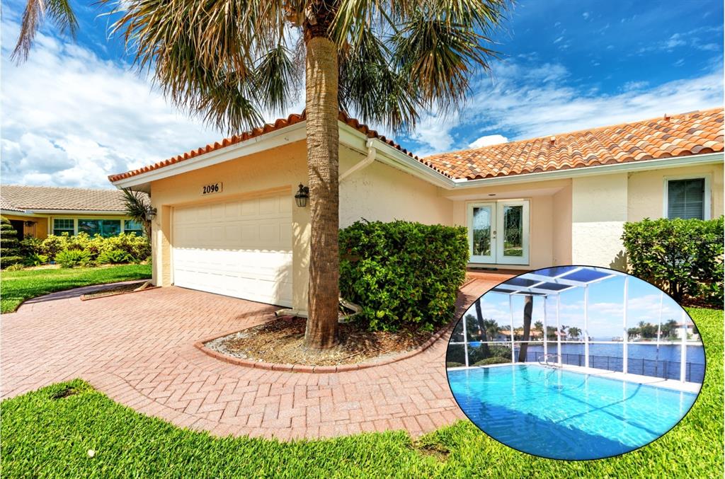 a view of a house with a swimming pool and sitting area