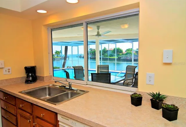a kitchen with stainless steel appliances a stove a refrigerator and a sink