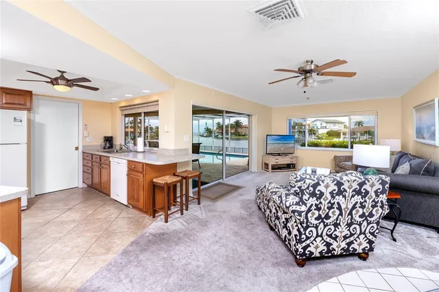 a living room with furniture a couch and a ceiling fan