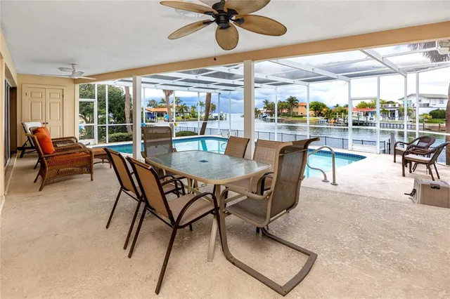 a view of a patio with dining table and chairs