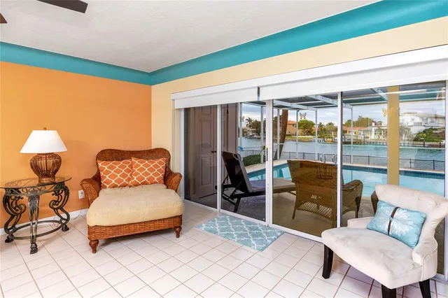 a living room with furniture and a large window with wooden floor