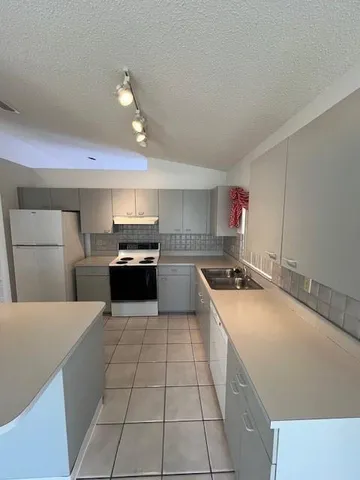 a kitchen with a cabinets and white appliances