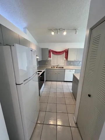a kitchen with a refrigerator a sink and a stove