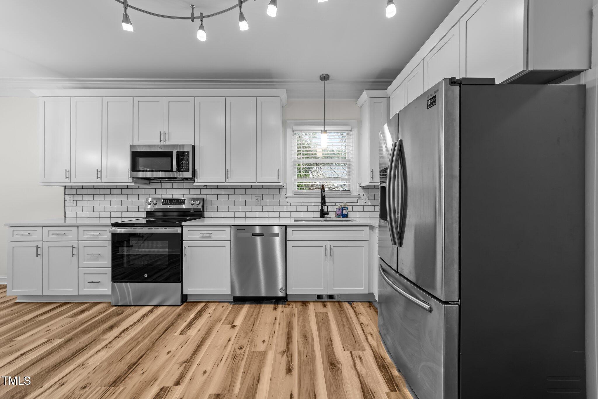 2913 Coxindale Drive Raleigh, NC 27615 - Photo 9 of 41 Sleek and Bright Kitchen