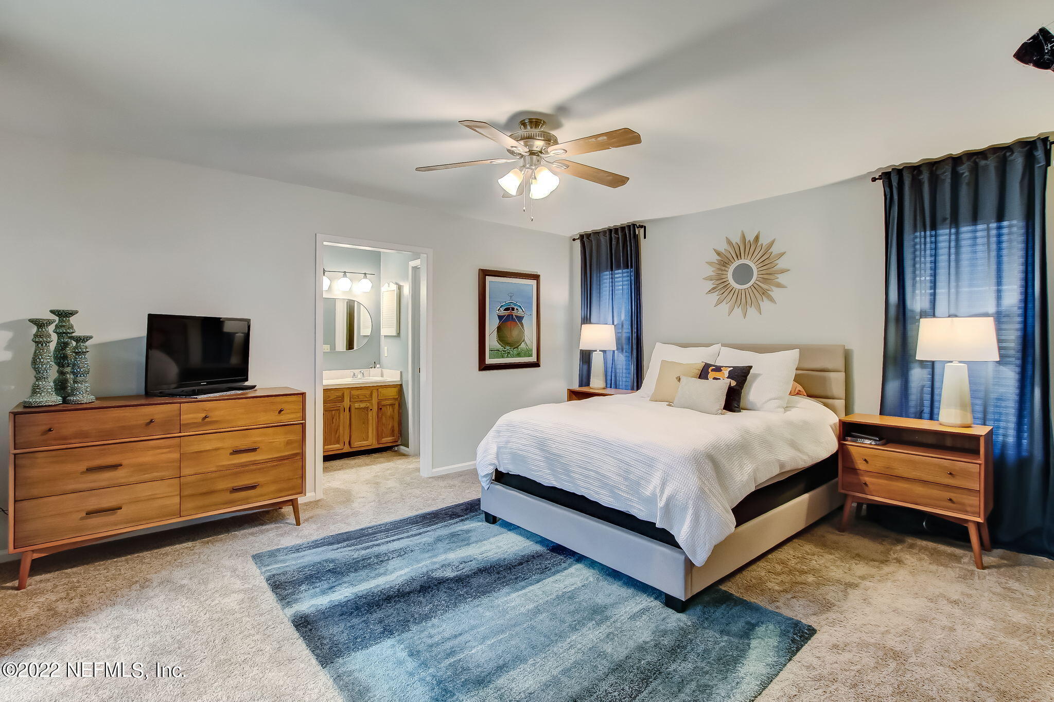 1618 Panther Ridge Court Jacksonville, FL 32225 - Photo 24 of 46 a spacious bedroom with a bed and a chandelier