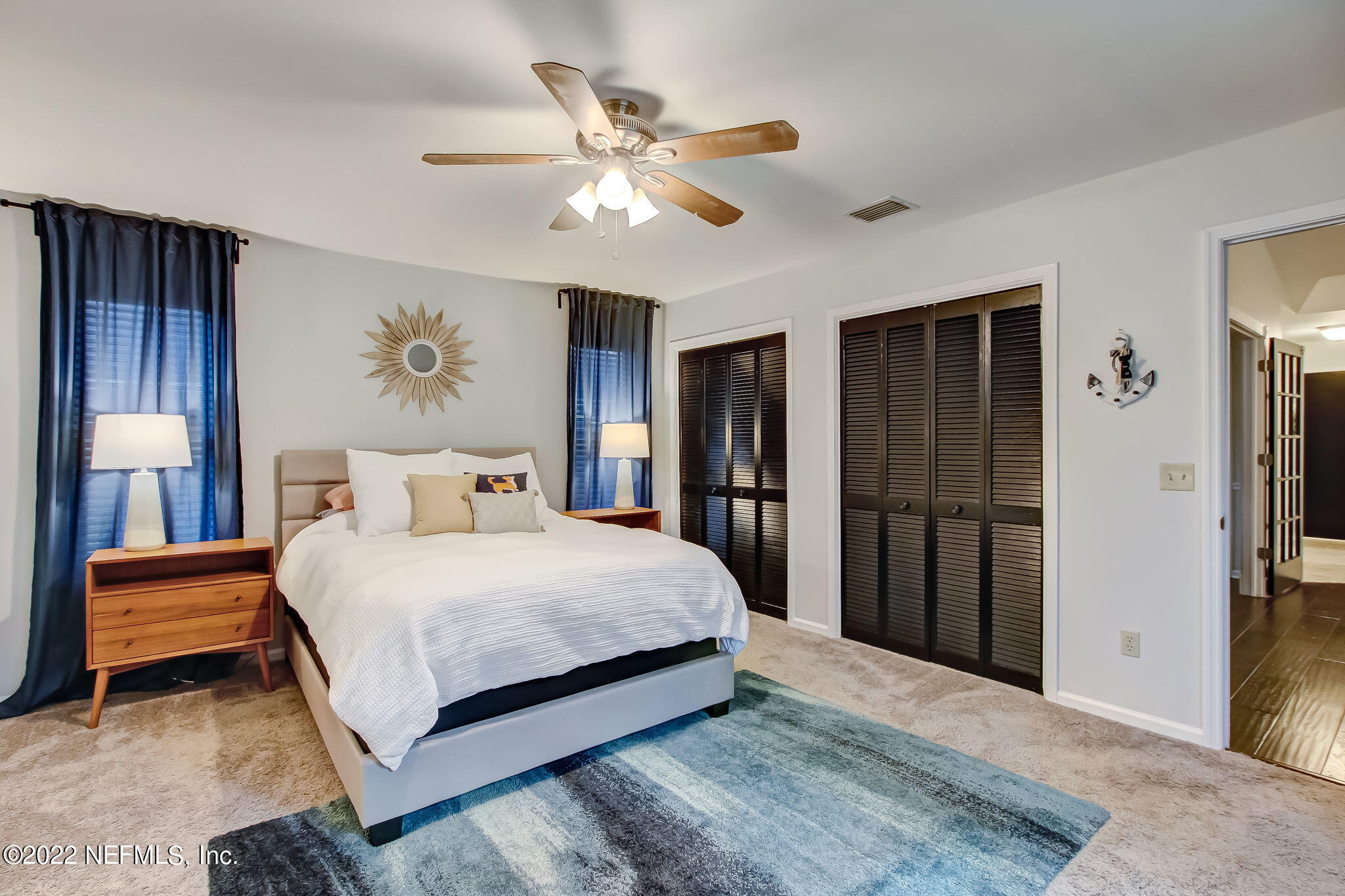 1618 Panther Ridge Court Jacksonville, FL 32225 - Photo 25 of 46 a bedroom with a bed and a chandelier