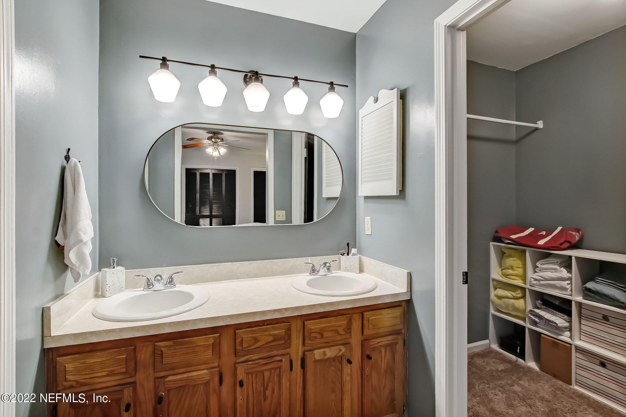 1618 Panther Ridge Court Jacksonville, FL 32225 - Photo 27 of 46 a bathroom with a double vanity sink and a mirror