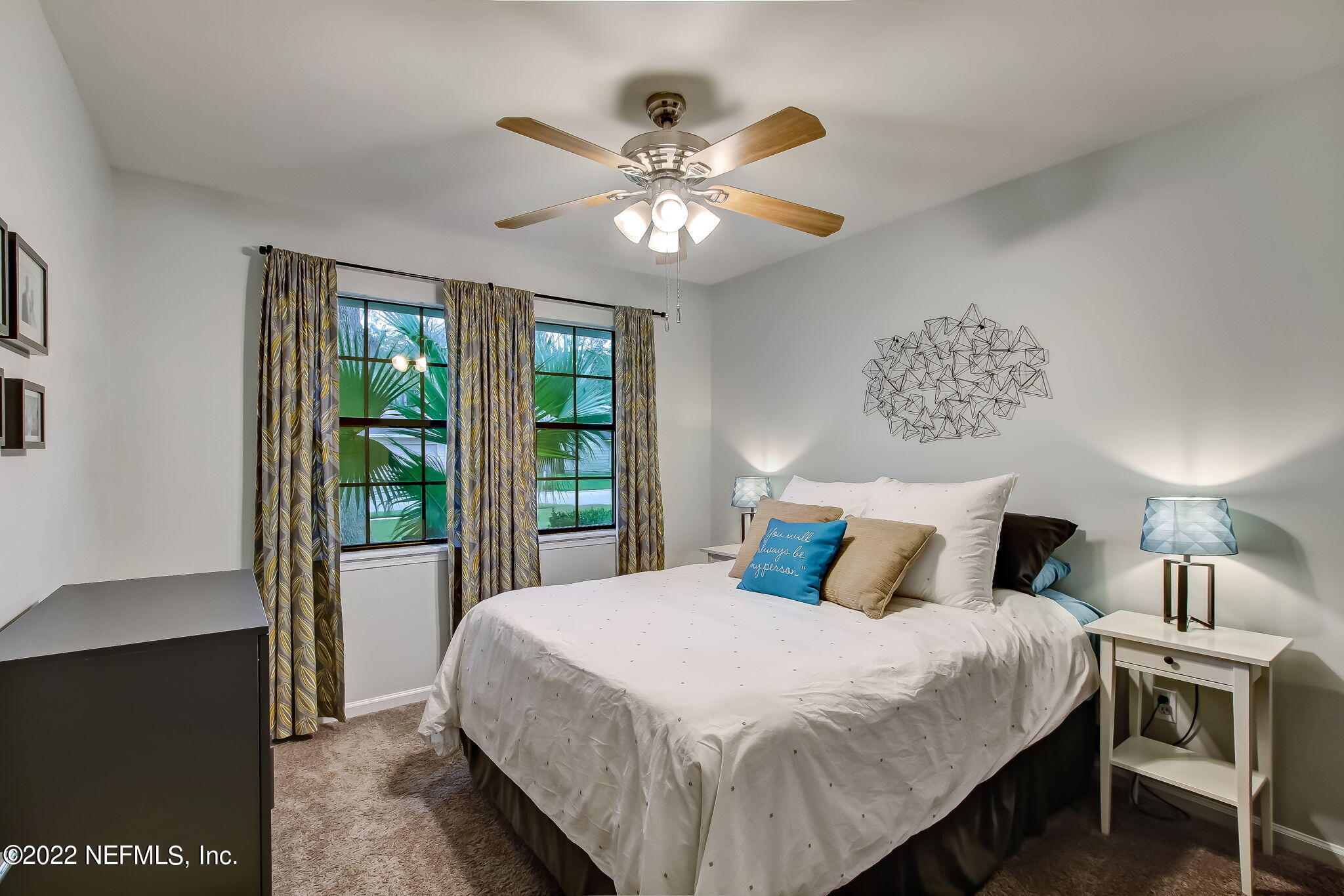 1618 Panther Ridge Court Jacksonville, FL 32225 - Photo 29 of 46 a bedroom with a large bed and a chandelier