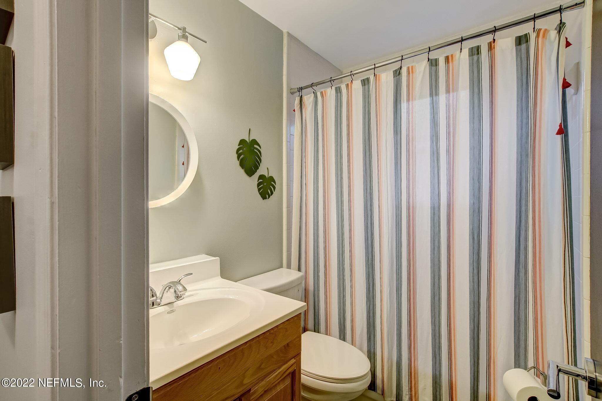 1618 Panther Ridge Court Jacksonville, FL 32225 - Photo 32 of 46 a bathroom with a sink a toilet and shower curtain