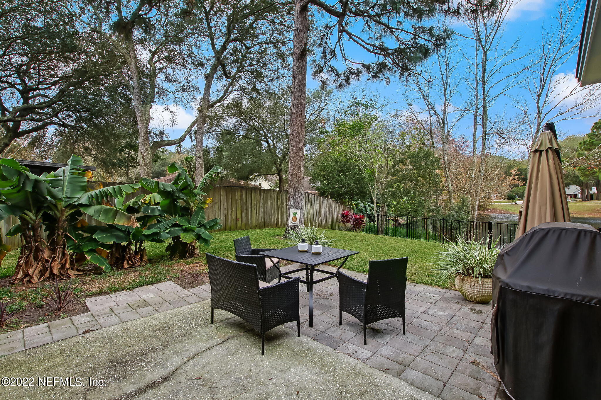 1618 Panther Ridge Court Jacksonville, FL 32225 - Photo 38 of 46 a backyard of a house with fountain table and chairs