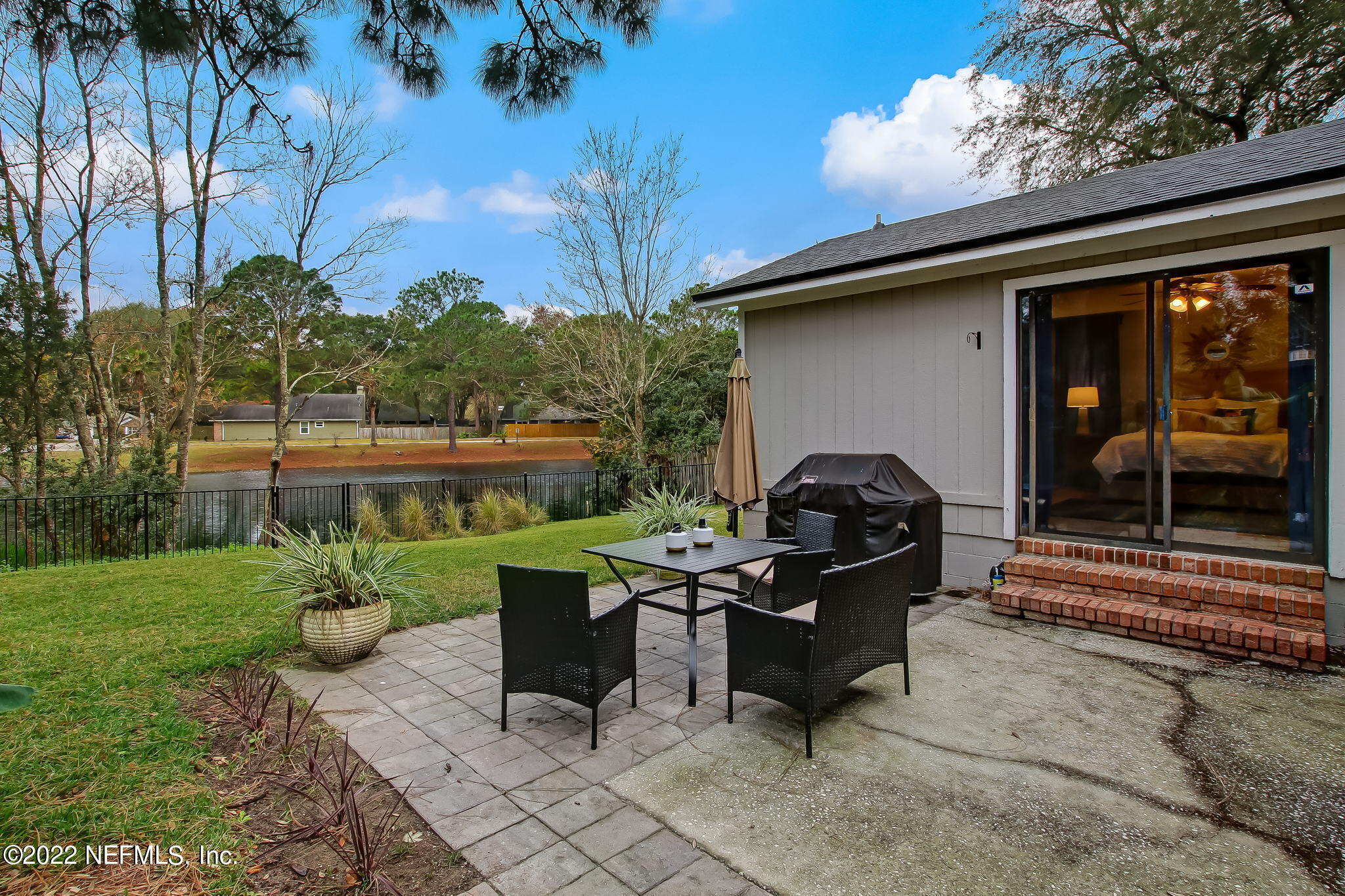 1618 Panther Ridge Court Jacksonville, FL 32225 - Photo 39 of 46 a backyard of a house with fountain table and chairs