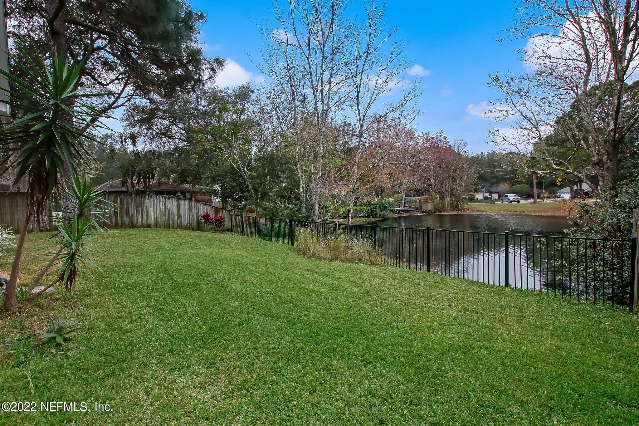 1618 Panther Ridge Court Jacksonville, FL 32225 - Photo 41 of 46 a backyard of a house with table and chairs and a large tree