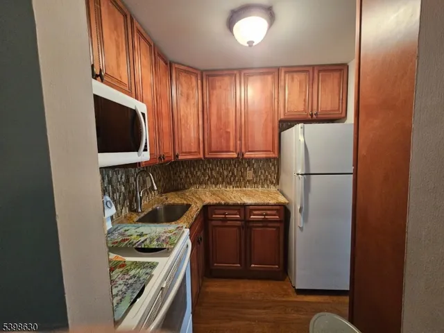 a kitchen with a refrigerator and a stove