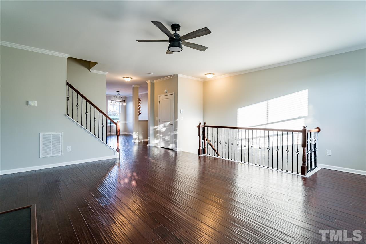 1521 Rodessa Run Raleigh, NC 27607 - Photo 12 of 29 View from the living room leading into the kitchen and dining area. Beautiful wrought iron spindles add to the airy feel in this large unit.