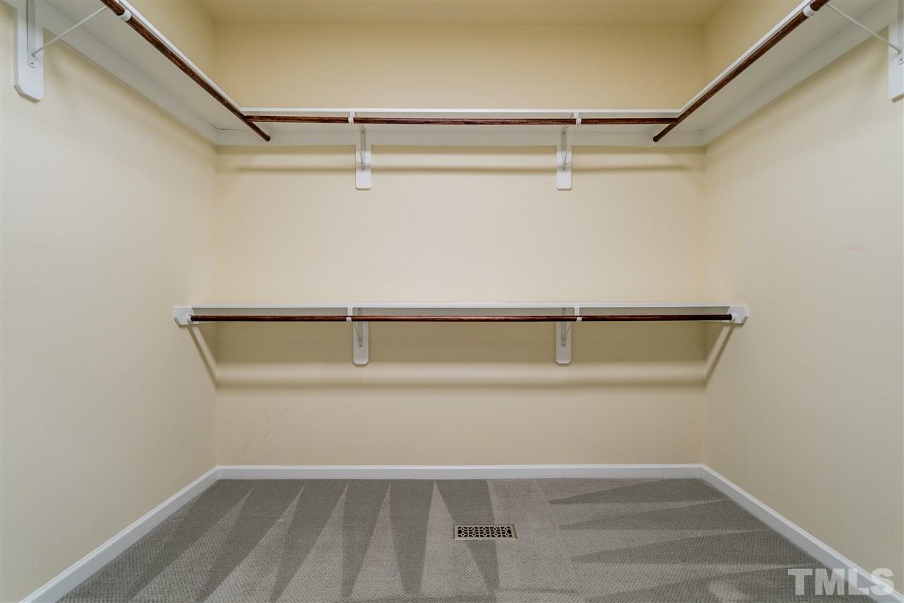 1521 Rodessa Run Raleigh, NC 27607 - Photo 22 of 29 Wooden shelving, tons of storage in your owner's suite walk in closet.