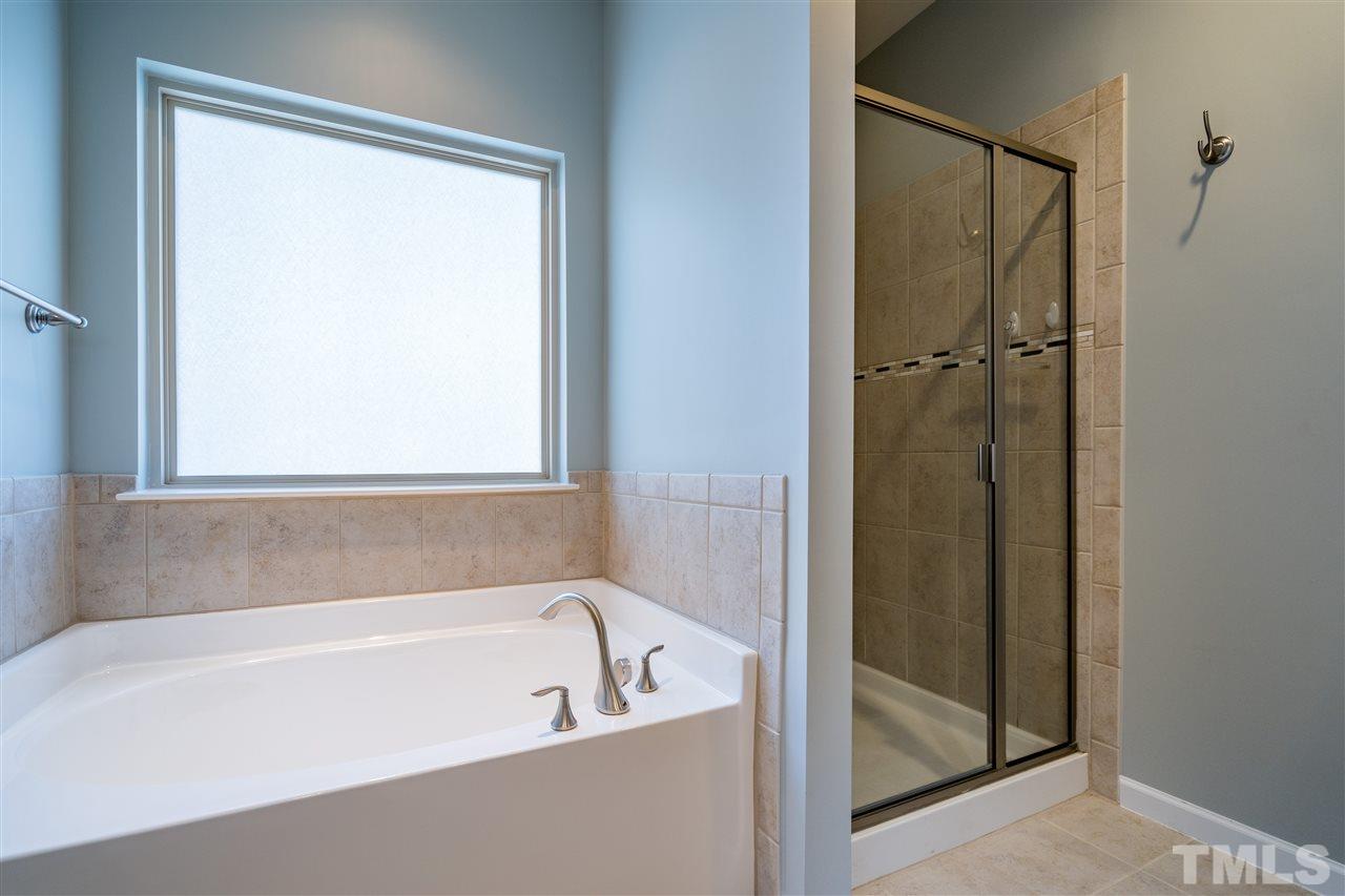 1521 Rodessa Run Raleigh, NC 27607 - Photo 24 of 29 Relax at the end of a hard day in your garden tub and enjoy the separate shower in this spacious spa like owner's retreat.