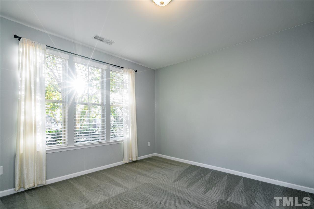 1521 Rodessa Run Raleigh, NC 27607 - Photo 4 of 29 First floor bedroom is great for guests or a private home office or gym. Closet with wooden shelving and full bath just outside the door.