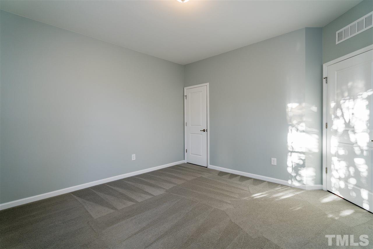 1521 Rodessa Run Raleigh, NC 27607 - Photo 5 of 29 First level bedroom view of private door to transition from the hallway and also the closet.
