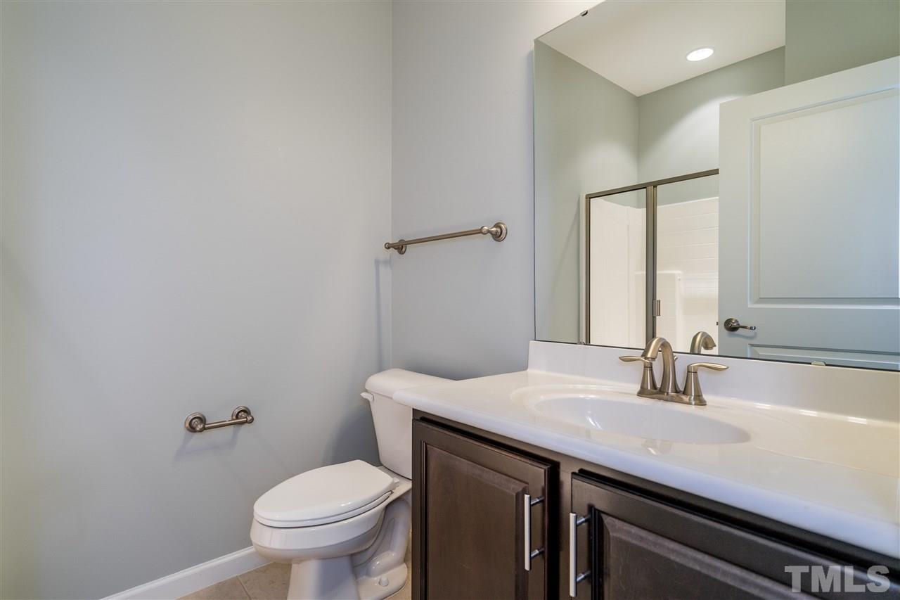 1521 Rodessa Run Raleigh, NC 27607 - Photo 6 of 29 Full bathroom on first level with step in shower and ceramic tile.