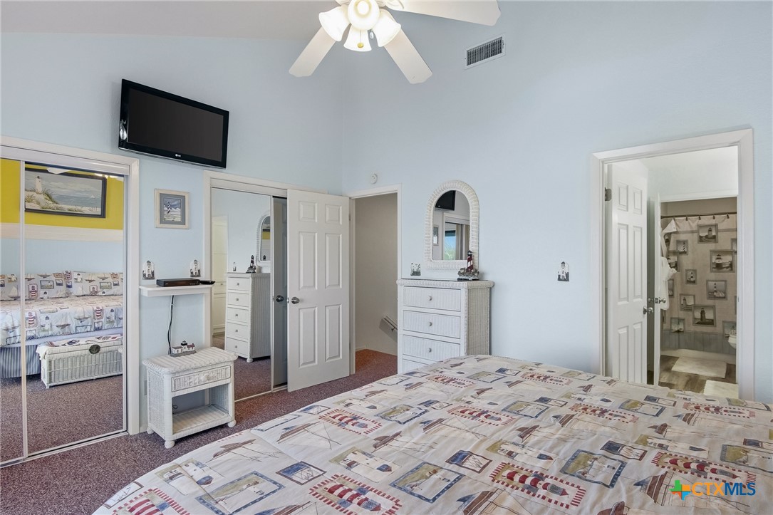 2292 North Fulton Beach Road, Unit 505 Rockport, TX 78382 - Photo 26 of 46 a bedroom with a bed and a flat screen tv