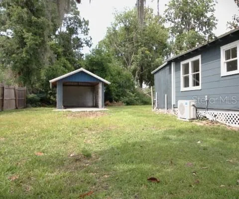 a house with green field in front of it