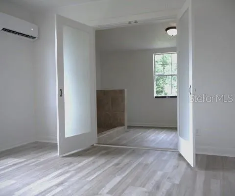 an empty room with windows and closet